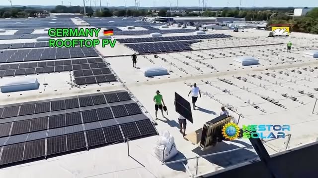 Nestor Solar team installing rows of solar panels on a large industrial rooftop in Germany